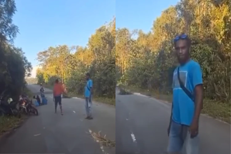 Tangkap layar video pemalak di salah satu jalan di Papua yang batal melakukan aksinya kepada seorang guru