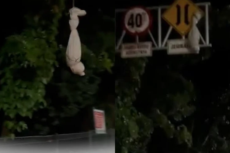 Sekelompok bocah menakuti warga dengan menggunakan pocong palsu di Jalan Raya Bukit Datuk, Kota Dumai, Riau.