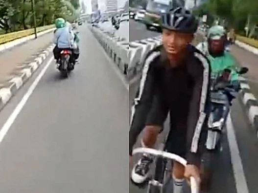 Video pengemudi ojol menendang pesepeda di jalur sepeda viral. Polisi selidiki dan imbau korban segera melapor.