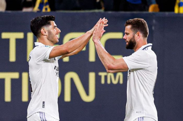 <p>Ket. Foto: Marco Asensio bersama Nacho, dua pencetak gol kemenangan untuk Real Madrid atas Cadiz di La Liga (Foto/Instagram/@realmadrid)</p>
